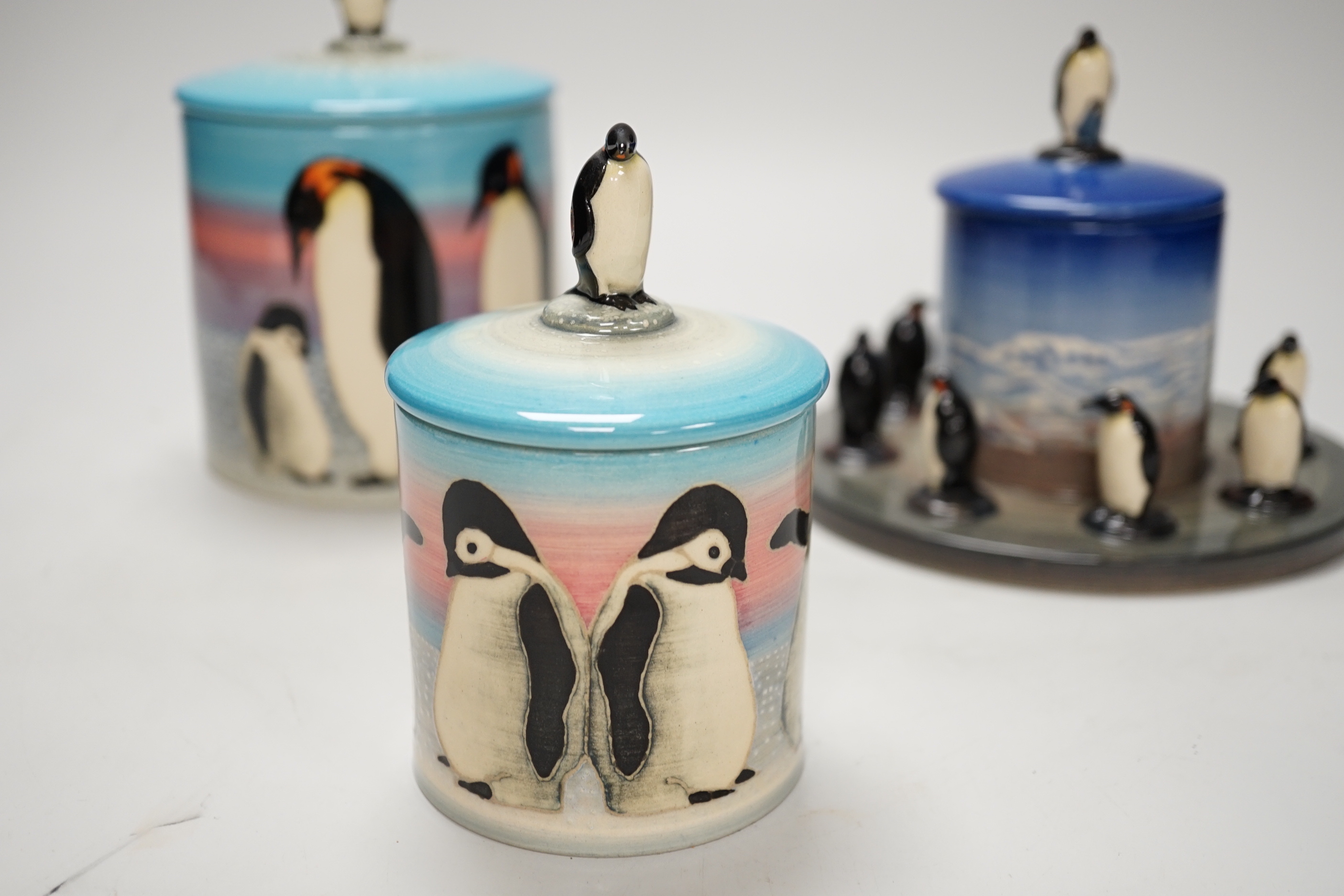 Three Sally Tuffin for Dennis China Works biscuit barrels with penguin knops, the largest 16cm high